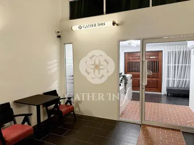 a room with a table and a glass door at Gather lnn in George Town