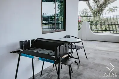 a barbecue grill with chairs and a table at Ipoh Midtown 66 Playhouse by Verve in Gua Sai