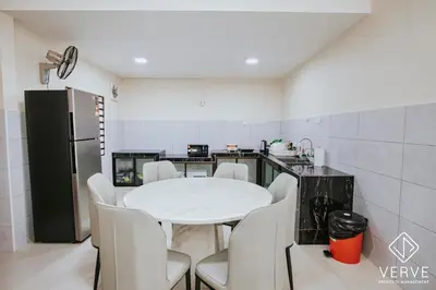 a kitchen with a white table and white chairs at Ipoh Midtown 66 Playhouse by Verve in Gua Sai