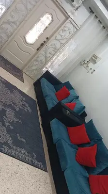 a room with two beds with red and blue pillows at Sutera Homestay in Sungai Petani