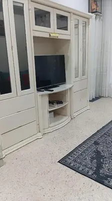 a white entertainment center with a television in it at Sutera Homestay in Sungai Petani