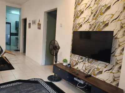 a living room with a flat screen tv on a wall at Ian's homestay II tanahrata chighlands in Tanah Rata