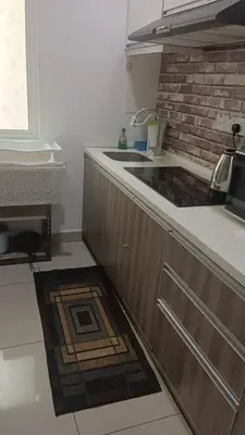 a kitchen with a sink and a counter top at Skyhauz Ipoh Cityview 2BR Homestay in Ipoh