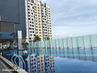 a building and a swimming pool in front of a building at Skyhauz Ipoh Cityview 2BR Homestay in Ipoh