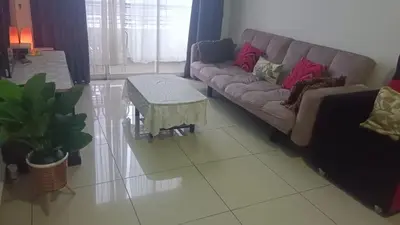 a living room with a couch and a table at Skyhauz Ipoh Cityview 2BR Homestay in Ipoh