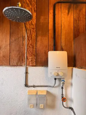 a light on the side of a wall at Just House - Rooms & Curios in George Town