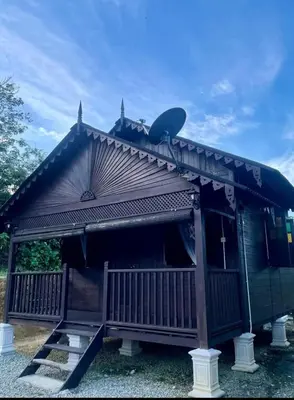 a small church with a cross on the roof at Pak Ayie Homestay in Batu Kurau