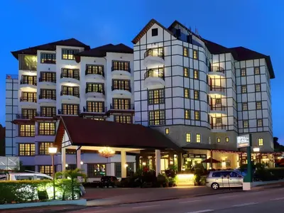 a large building with a car parked in front of it at Cameron Highland 3 Bedroom Apartment in Cameron Highlands