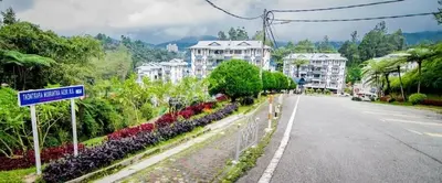 an empty street with a street sign and buildings at Cameron Highland 3 Bedroom Apartment in Cameron Highlands