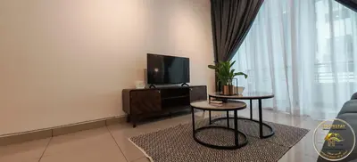a living room with a tv and two tables at Heart of Town Free WIFI -Majestic Ipoh By Hopestay in Ipoh