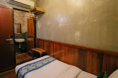 a small room with a bed and a sink at Anggun Hotel in Seri Iskandar