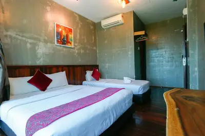 a hotel room with two beds and a bathroom at Anggun Hotel in Seri Iskandar