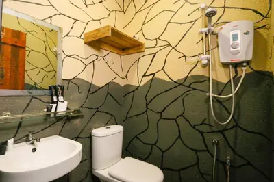 a bathroom with a toilet and a sink at Anggun Hotel in Seri Iskandar