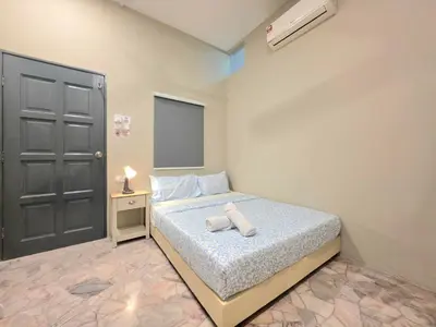 a bedroom with a bed with two towels on it at Room at Macalister nearto LohGuanLye Specialists in George Town