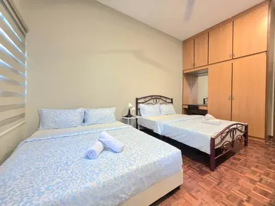 a bedroom with two beds with blue pillows at Room at Macalister nearto LohGuanLye Specialists in George Town