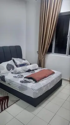 a bed sitting in a room next to a window at Homestay PPAM Dalur Apartment Presint 18,Putrajaya in Gua Sai
