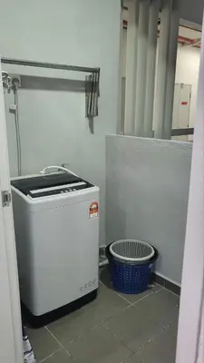 a washing machine sitting on the floor in a room at Homestay PPAM Dalur Apartment Presint 18,Putrajaya in Gua Sai