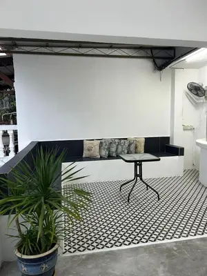 a table on a tiled floor in a room at Comfortable two-storey terrace house near main road perai in Perai