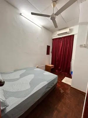 a bedroom with a bed and a red curtain at Comfortable two-storey terrace house near main road perai in Perai