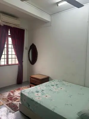 a bedroom with a bed and a window at Comfortable two-storey terrace house near main road perai in Perai