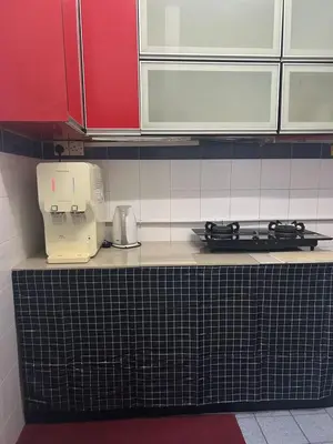 a kitchen counter with a coffee maker and a toaster at Comfortable two-storey terrace house near main road perai in Perai