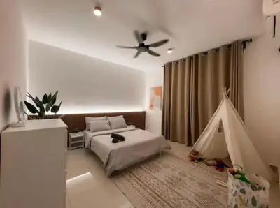 a bedroom with a bed and a play tent at Casa Home Homestay Lunas in Lunas