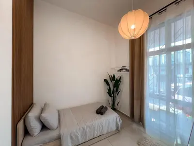 a room with a bed and a large window at Casa Home Homestay Lunas in Lunas