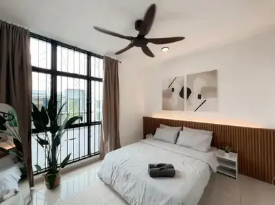 a bedroom with a bed with a ceiling fan at Casa Home Homestay Lunas in Lunas