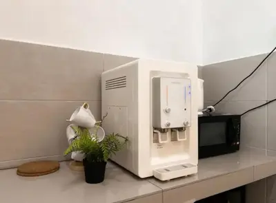 a microwave oven sitting on a counter with a plant at Casa Home Homestay Lunas in Lunas