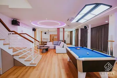 a living room with a pool table and a skylight at Ipoh 55 Private Pool By Verve 26PAX in Ipoh