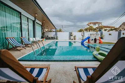 a swimming pool with chairs and a pool slide at Ipoh 55 Private Pool By Verve 26PAX in Ipoh