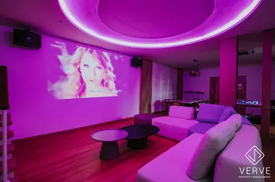 a purple room with a couch and a table at Ipoh 55 Private Pool By Verve 26PAX in Ipoh