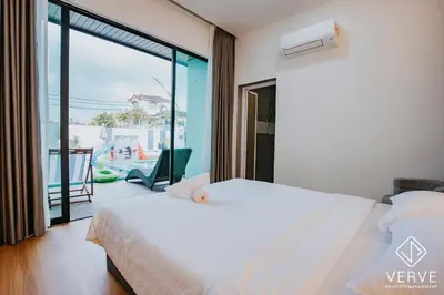 a bedroom with a white bed and a balcony at Ipoh 55 Private Pool By Verve 26PAX in Ipoh