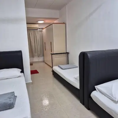 a small room with two beds and a cabinet at Setia Arena Penang, Queensbay, Airport, Bridge, Wetmarket, Nasi Kandar in Bayan Lepas