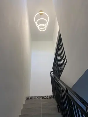 a hallway with a staircase with a light fixture at Cozy Homestay, Tasek Idaman Town, Batu Gajah in Batu Gajah
