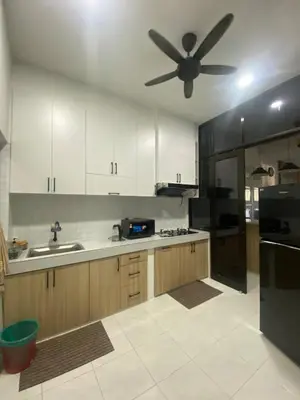 a kitchen with white cabinets and a ceiling fan at Cozy Homestay, Tasek Idaman Town, Batu Gajah in Batu Gajah
