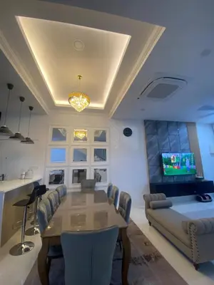 a dining room with a table and a couch at Cozy Homestay, Tasek Idaman Town, Batu Gajah in Batu Gajah