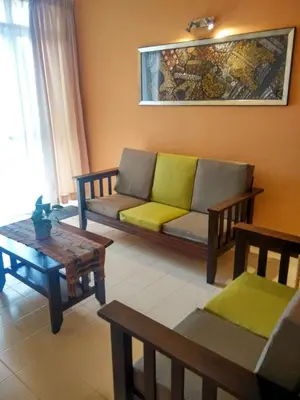 a living room with a couch and a table at Jean CleanComfy Apt Near Beach in Batu Ferringhi