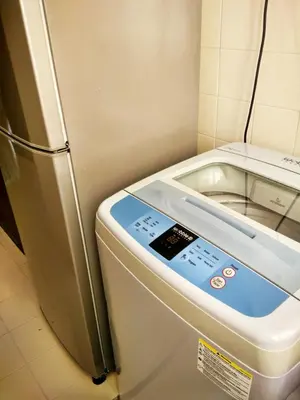 a refrigerator with a digital screen next to it at Jean CleanComfy Apt Near Beach in Batu Ferringhi