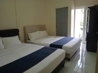 a bedroom with two beds and a window at Netasha Holiday INN in Tanah Rata