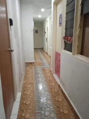 a hallway with a tile floor in a hallway at Netasha Holiday INN in Tanah Rata