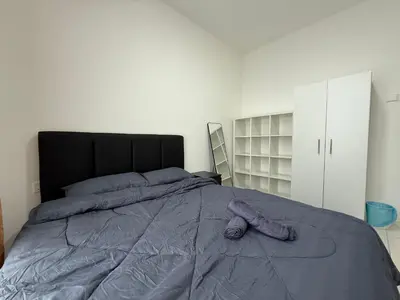 a bedroom with a large bed with a purple blanket at Ipoh Town 3pax Suite The Anderson Residence #516 in Ipoh
