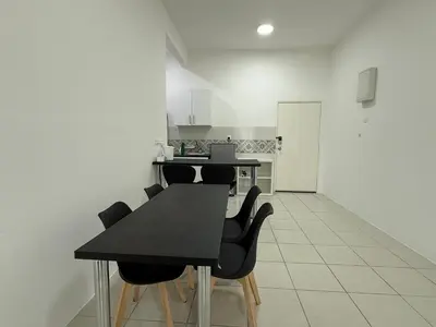 a kitchen with a black table and black chairs at Ipoh Town 3pax Suite The Anderson Residence #516 in Ipoh