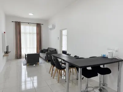 a living room with a black table and chairs at Ipoh Town 3pax Suite The Anderson Residence #516 in Ipoh