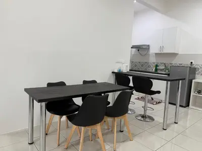 a kitchen with a black table and chairs at Ipoh Town 3pax Suite The Anderson Residence #516 in Ipoh