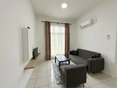 a living room with a couch and a tv at Ipoh Town 3pax Suite The Anderson Residence #516 in Ipoh