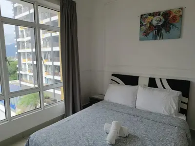 a bedroom with a bed and a large window at Heart of Ipoh 2BR 6pp in Ipoh