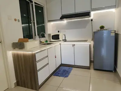 a kitchen with white cabinets and a blue refrigerator at Heart of Ipoh 2BR 6pp in Ipoh