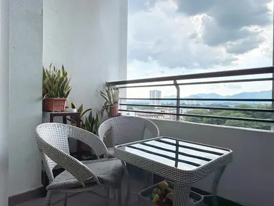a balcony with chairs and a table and a view of the ocean at Heart of Ipoh 2BR 6pp in Ipoh
