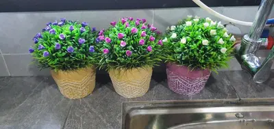 three vases filled with purple and white flowers on a counter at REZEKI MUEZZA 3BR2B Cozy Homestay in Teluk Intan